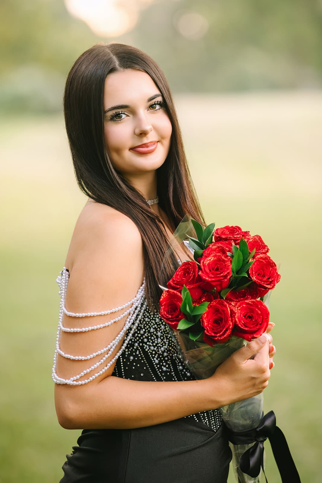 Lake Jackson senior girl in a silver Homecoming dress holding red roses